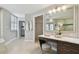 Bright bathroom featuring a vanity area, double sinks, and water closet at 19820 Gulf Blvd # 401, Indian Shores, FL 33785