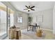 Sun-filled home office with a modern ceiling fan and sliding glass doors to balcony at 19820 Gulf Blvd # 401, Indian Shores, FL 33785