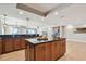 Open kitchen featuring an island with a sink and views of the living and dining areas at 19820 Gulf Blvd # 401, Indian Shores, FL 33785