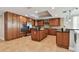 Spacious kitchen featuring custom wood cabinetry, stainless steel appliances, and a large island at 19820 Gulf Blvd # 401, Indian Shores, FL 33785
