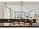 Eat-in kitchen view with countertops, a stainless steel sink, and pendant lighting at 19820 Gulf Blvd # 401, Indian Shores, FL 33785