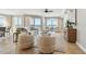 Bright living room featuring beach views, comfortable seating, and neutral tones, creating a relaxing atmosphere at 19820 Gulf Blvd # 401, Indian Shores, FL 33785