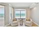 Cozy sitting area features beach views, comfortable chairs, and a serene atmosphere perfect for relaxation at 19820 Gulf Blvd # 401, Indian Shores, FL 33785