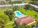 Aerial shot of the property featuring a pool surrounded by lush green lawns and trees at 5095 Bay Ne St # 114, St Petersburg, FL 33703