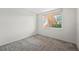 Well-lit bedroom features soft carpet and a bright window view at 5095 Bay Ne St # 114, St Petersburg, FL 33703