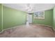 Spacious bedroom with plush carpet, ceiling fan, and natural light at 5095 Bay Ne St # 114, St Petersburg, FL 33703