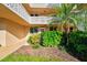 Well-maintained condo entrance with lush landscaping, providing a welcoming feel at 5095 Bay Ne St # 114, St Petersburg, FL 33703