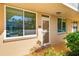 Exterior view of unit with large windows, a screen door, and well-maintained landscaping at 5095 Bay Ne St # 114, St Petersburg, FL 33703