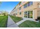 Exterior shot of condo building with a sidewalk and grassy area at 5095 Bay Ne St # 114, St Petersburg, FL 33703