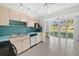 Kitchen with a stainless steel dishwasher, light wood cabinets and sliding glass doors to the outside at 5095 Bay Ne St # 114, St Petersburg, FL 33703