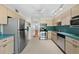 Charming kitchen featuring stainless steel appliances, teal countertops, and ample cabinet space at 5095 Bay Ne St # 114, St Petersburg, FL 33703