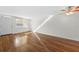 Bright living room features hardwood floors, a ceiling fan, and a large window at 5095 Bay Ne St # 114, St Petersburg, FL 33703