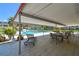 Relaxing poolside patio with lounge chair, tables, and chairs, perfect for outdoor enjoyment at 5095 Bay Ne St # 114, St Petersburg, FL 33703