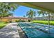 View of shuffleboard courts near the building and community area surrounded by trees and greenery at 5095 Bay Ne St # 114, St Petersburg, FL 33703
