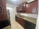 Kitchen with granite countertops and wood cabinets at 455 Alt 19 S # 21, Palm Harbor, FL 34683
