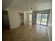 Bright living room with tile floors and sliding glass door at 455 Alt 19 S # 21, Palm Harbor, FL 34683