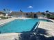 Community pool with lounge chairs and surrounding patio at 455 Alt 19 S # 21, Palm Harbor, FL 34683