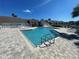 Community pool with lounge chairs and surrounding patio at 455 Alt 19 S # 21, Palm Harbor, FL 34683