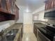 Kitchen with granite countertops and wood cabinets at 455 Alt 19 S # 21, Palm Harbor, FL 34683