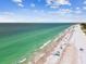 Aerial view of beach with clear water and people enjoying the sun at 19820 Gulf Blvd # 401, Indian Shores, FL 33785