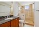 Bathroom with granite vanity, tiled shower, and a toilet at 19820 Gulf Blvd # 401, Indian Shores, FL 33785