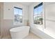 Bright bathroom featuring a stand-alone tub and a large window at 135 48Th Ave, St Petersburg, FL 33703