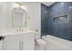 Stylish bathroom featuring a tub with navy tile surround, and white vanity at 135 48Th Ave, St Petersburg, FL 33703