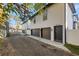 Modern exterior of the building with gray doors, two garage doors, and a private side entrance at 135 48Th Ave, St Petersburg, FL 33703