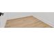 Light wood grain vinyl flooring with crisp white baseboards at 135 48Th Ave, St Petersburg, FL 33703