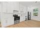 Modern kitchen featuring white cabinetry, stainless steel appliances, and sleek countertops at 135 48Th Ave, St Petersburg, FL 33703