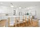 Open kitchen featuring a large island with barstool seating, white cabinets, and modern appliances at 135 48Th Ave, St Petersburg, FL 33703