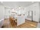 Bright, open kitchen featuring a large marble island, white cabinets, and modern appliances at 135 48Th Ave, St Petersburg, FL 33703