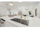 Open-concept kitchen with a spacious island, stainless steel sink, and modern finishes, perfect for entertaining guests at 135 48Th Ave, St Petersburg, FL 33703