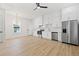 Bright open kitchen with stainless steel appliances, white cabinets, and light wood floors at 135 48Th Ave, St Petersburg, FL 33703