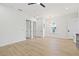 Spacious living area features hardwood floors, neutral paint and modern lighting fixture at 135 48Th Ave, St Petersburg, FL 33703