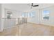 Bright loft space with hardwood floors, large windows, and a black railing at 135 48Th Ave, St Petersburg, FL 33703