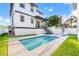 Beautiful backyard featuring a sparkling swimming pool, lounge chairs, and lush greenery at 135 48Th Ave, St Petersburg, FL 33703