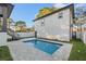 Private backyard oasis featuring a sparkling pool, paved patio, and lush landscaping at 135 48Th Ave, St Petersburg, FL 33703