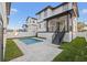 Backyard with a private pool surrounded by a paved patio and well-manicured lawn at 135 48Th Ave, St Petersburg, FL 33703