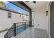 View from the covered porch to the fenced in backyard with a rectangular pool at 135 48Th Ave, St Petersburg, FL 33703