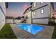 Backyard view of a refreshing pool surrounded by lush green landscaping at 135 48Th Ave, St Petersburg, FL 33703