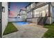 Backyard view showcasing a private pool and manicured landscaping at dusk at 135 48Th Ave, St Petersburg, FL 33703