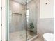 Contemporary shower with glass enclosure, neutral tile, and gold hardware at 135 48Th Ave, St Petersburg, FL 33703