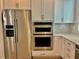 Kitchen with stainless steel appliances, white cabinets, and quartz countertop at 2511 N Grady Ave # 53, Tampa, FL 33607