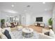 Staged living room with comfortable furniture, neutral colors, and modern decor at 2511 N Grady Ave # 53, Tampa, FL 33607