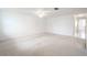 Large bedroom with ceiling fan and grey laminate flooring at 3543 Seffner Dr, Holiday, FL 34691