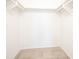 Large walk-in closet with double hanging rods and tile flooring at 3543 Seffner Dr, Holiday, FL 34691