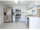 Kitchen with stainless steel appliances and white cabinets at 3543 Seffner Dr, Holiday, FL 34691