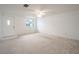 Bright living room with neutral carpeting and exterior view at 3543 Seffner Dr, Holiday, FL 34691