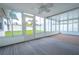 Bright sunroom with backyard view and carpet flooring at 3543 Seffner Dr, Holiday, FL 34691